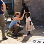 Kelly and a little girl in a high-5
