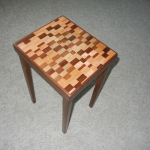 Small end table with laminated top, walnut rim and legs