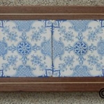 Antique Delft tiles with inlaid walnut frame